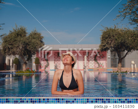 asian woman relaxing in swimming pool spa asian woman relaxing in swimming pool spa 103411830