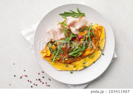 Portion of omelette breakfast with smoked chicken Portion of omelette breakfast with smoked chicken 103411987