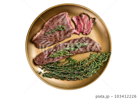 BBQ grilled Bavette Bavet beef meat steak with herbs on a plate. Isolated on white background. 103412226