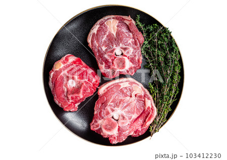 Raw Lamb Gerdan, lamb neck chops on a plate with herbs. Isolated on white background. 103412230