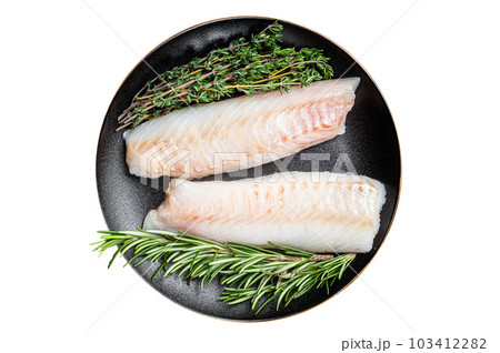 Raw cod loin fillet steaks with herbs on plate. Isolated on white background. 103412282