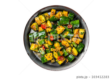Chinese smashed cucumber salad with chili peppers and sesame seeds. Isolated on white background. 103412283