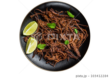 Carnitas in a plate with celery and lime wedges. Isolated on white background. Carnitas in a plate with celery and lime wedges. Isolated on white background. 103412284