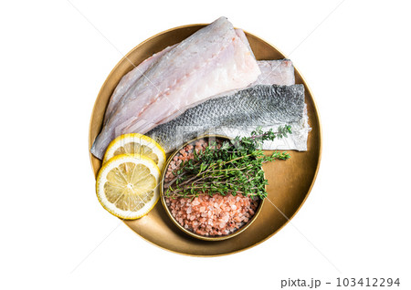 Uncooked Raw Sea Bass fillets, Seabass fish with thyme, pink salt and lemon. Isolated on white background. Uncooked Raw Sea Bass fillets, Seabass fish with thyme, pink salt and lemon. Isolated on white background. 103412294