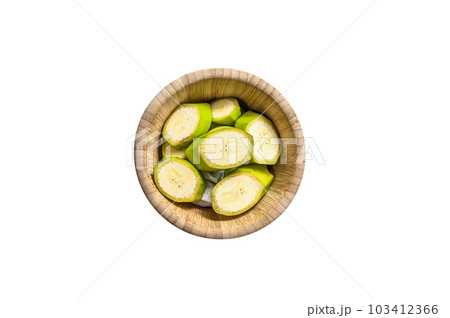 Sliced green banana in a wooden bowl. Isolated on white background. Sliced green banana in a wooden bowl. Isolated on white background. 103412366