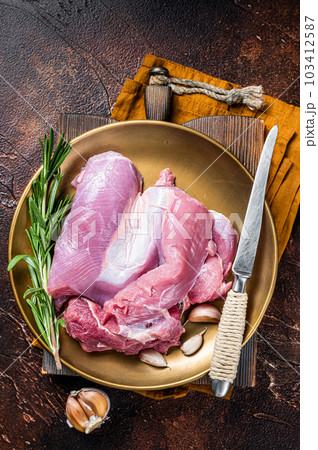 Fresh skinless raw Turkey thigh fillet meat with spices. Dark background. Top view Fresh skinless raw Turkey thigh fillet meat with spices. Dark background. Top view 103412587