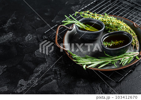 Assorted fresh herbs with olive oil. Top view. Dark background. Copy space. 103412670