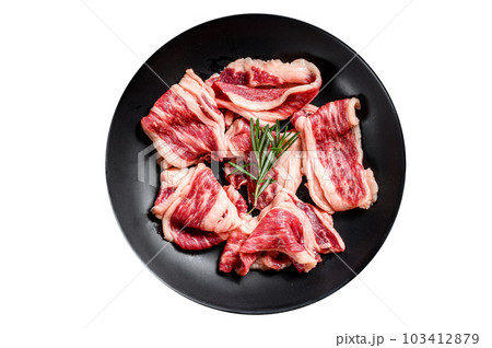 Raw beef bacon, marbled meat in a plate. Isolated on white background. 103412879