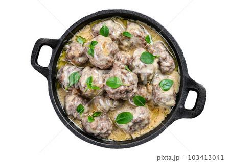 Beef meatballs in cream sauce in a frying pan. Isolated on white background. Beef meatballs in cream sauce in a frying pan. Isolated on white background. 103413041