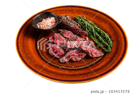 Medium rare Sliced grilled Onglet Hanging Tender meat beef steak on a plate. Isolated on white background. 103413578