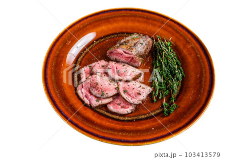 Barbecue Sliced veal tender fillet meat steak on a plate. Isolated on white background. 103413579