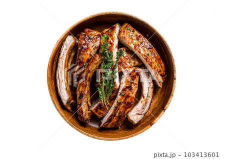 Cut BBQ grilled pork rack spareribs in a wooden plate. Isolated on white background. 103413601