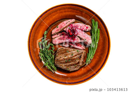 Fried sliced flank or bavette beef meat steak on a plate. Isolated on white background. 103413613
