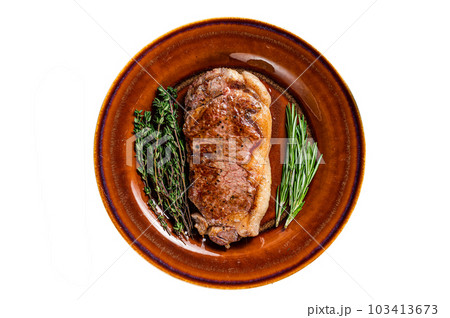 Roasted new york strip beef meat steak or striploin in a rustic plate. Isolated on white background. Roasted new york strip beef meat steak or striploin in a rustic plate. Isolated on white background. 103413673