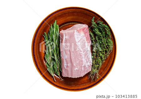 Fresh Raw pork loin meat with thyme and rosemary on rustic plate. Isolated on white background. 103413885