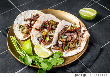 Mexican Beef Barbacoa Tacos with Cilantro and Onion. Black background. Top view 103414143
