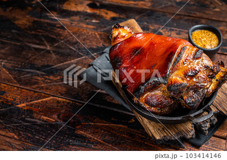 Bavarian Schweinshaxe Roast pork Hock Ham, knuckle with Sauerkraut. Wooden background. Top view. Copy space Bavarian Schweinshaxe Roast pork Hock Ham, knuckle with Sauerkraut. Wooden background. Top view. Copy space 103414146