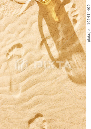 Shadow of beer mug on warm sand. Textured image. Beach chili on warm summer day with cool drink, refreshment and relaxation 103414409
