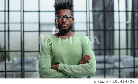 Portrait of a smiling CEO at workplace in a modern office in casual wear with glasses 103414708