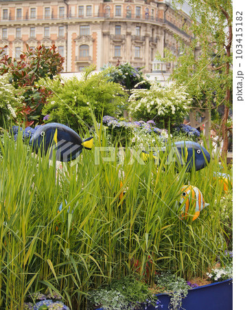 Installation on a marine theme, fish in the grass. Details of the garden interior, marine-style decoration. 103415182