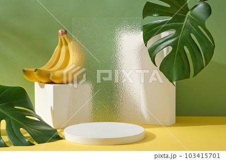 Modern composition of geometric shape podiums, transparent acrylic sheet with a banana bunch. Blank space on the podium for product promotion of Banana extract 103415701