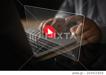 Man plays video media while watching a webinar on a laptop or screen technology interface communication call future meeting video 103415858