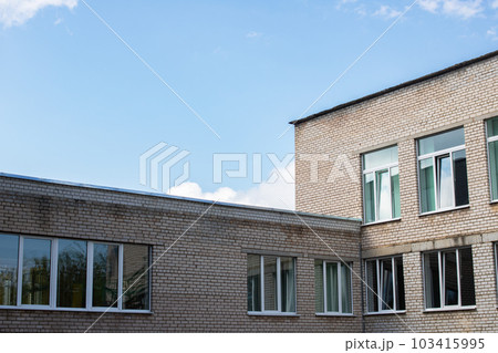 Building windows on blue cloudy sky background Building windows on blue cloudy sky background 103415995