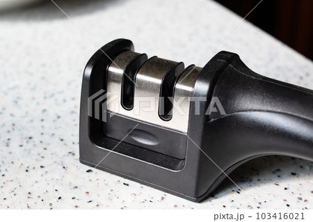 Black knife sharpener on the table closeup 103416021