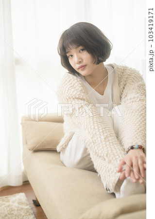 ソファでくつろぐ若い女性（ブラックミストフィルター） 103419171