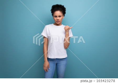confused owner of curly hair woman dressed in a white t-shirt 103423278