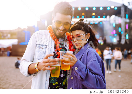 Couple with beer at music festival. Summer Beach party, holiday, vacation concept. Couple with beer at music festival. Summer Beach party, holiday, vacation concept. 103425249