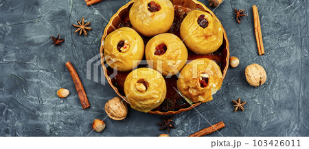 Baked autumn apples with nuts and raisins 103426011