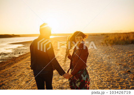 Enjoying time together. Stylish and loving couple enjoying each other by the sea. Enjoying time together. Stylish and loving couple enjoying each other by the sea. 103426719