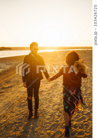 Enjoying time together. Stylish and loving couple enjoying each other by the sea. Enjoying time together. Stylish and loving couple enjoying each other by the sea. 103426720