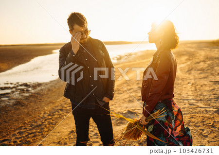 Enjoying time together. Stylish and loving couple enjoying each other by the sea. Enjoying time together. Stylish and loving couple enjoying each other by the sea. 103426731