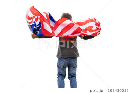 Patriotic american boy holding USA flag waving in the wind isolated on white  103430013