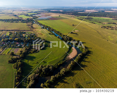 Agricultural fields along the river in the countryside Agricultural fields along the river in the countryside 103430219