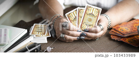 Concept of psychic advisor or ways of divination with cards. Concept of psychic advisor or ways of divination with cards. 103433989