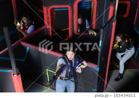Team of young people play laser tag in labyrinth. View from above 103434811