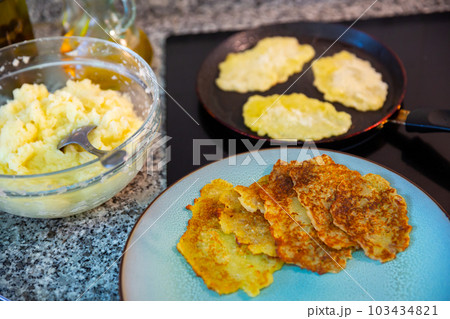 Preparation of potato pancakes on frying pan 103434821