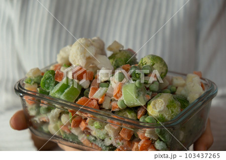 Unrecognizable woman showing Frozen mixed vegetables homemade. Harvesting concept. Stocking up vegetables for winter storage Unrecognizable woman showing Frozen mixed vegetables homemade. Harvesting concept. Stocking up vegetables for winter storage 103437265