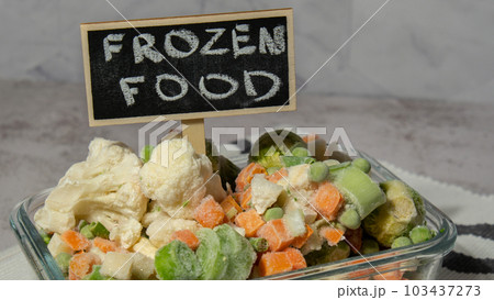 Frozen mixed vegetables for long-term storage with blackboard label and text FROZEN FOOD. Deep freezing of vegetables. defrosting Frozen food background Frozen mixed vegetables for long-term storage with blackboard label and text FROZEN FOOD. Deep freezing of vegetables. defrosting Frozen food background 103437273