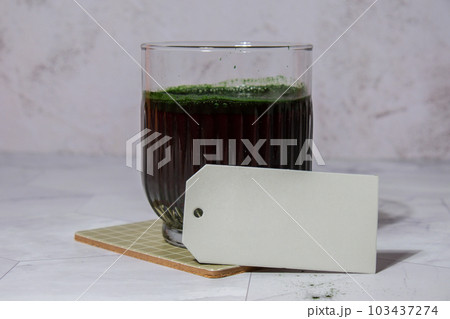 Blue-green algae Chlorella and spirulina powder drink with empty paper note copy space. Super powder. Natural supplement of algae. Detox superfood drink cocktail. Food supplement source of protein and Blue-green algae Chlorella and spirulina powder drink with empty paper note copy space. Super powder. Natural supplement of algae. Detox superfood drink cocktail. Food supplement source of protein and 103437274