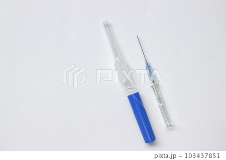 IV catheter with a needle sheath placed on white background. 103437851