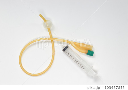 Urinary catheter with syringe 10 ml on a white background, test 103437853