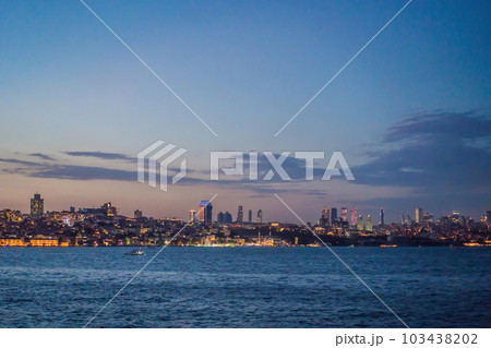 Istanbul at sunset, Turkey. Tourist boat sails on Golden Horn in summer. Beautiful sunny view of Istanbul waterfront with old mosque. Concept of travel, tourism and vacation in Istanbul and Turkey Istanbul at sunset, Turkey. Tourist boat sails on Golden Horn in summer. Beautiful sunny view of Istanbul waterfront with old mosque. Concept of travel, tourism and vacation in Istanbul and Turkey 103438202