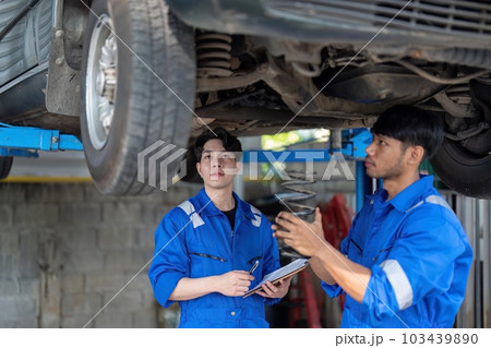 car mechanic car suspension detail of lifted automobile at repair service station car mechanic car suspension detail of lifted automobile at repair service station 103439890