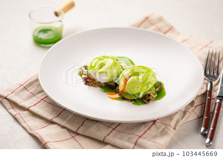 Portion of breakfast with poached egg and sauce 103445669