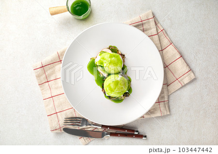 Portion of breakfast with poached egg and sauce Portion of breakfast with poached egg and sauce 103447442