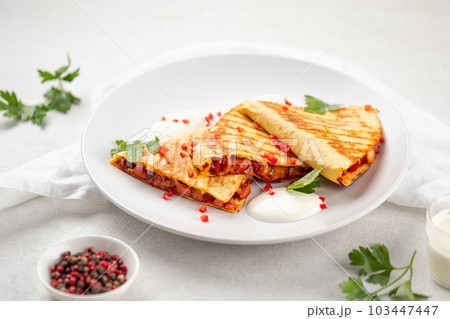 Portion of appetizing quesadilla wrap with chicken Portion of appetizing quesadilla wrap with chicken 103447447